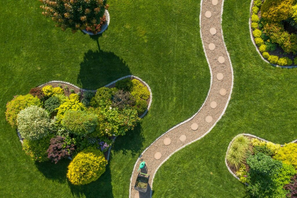 mature backyard garden with large grass lawn aerial vista